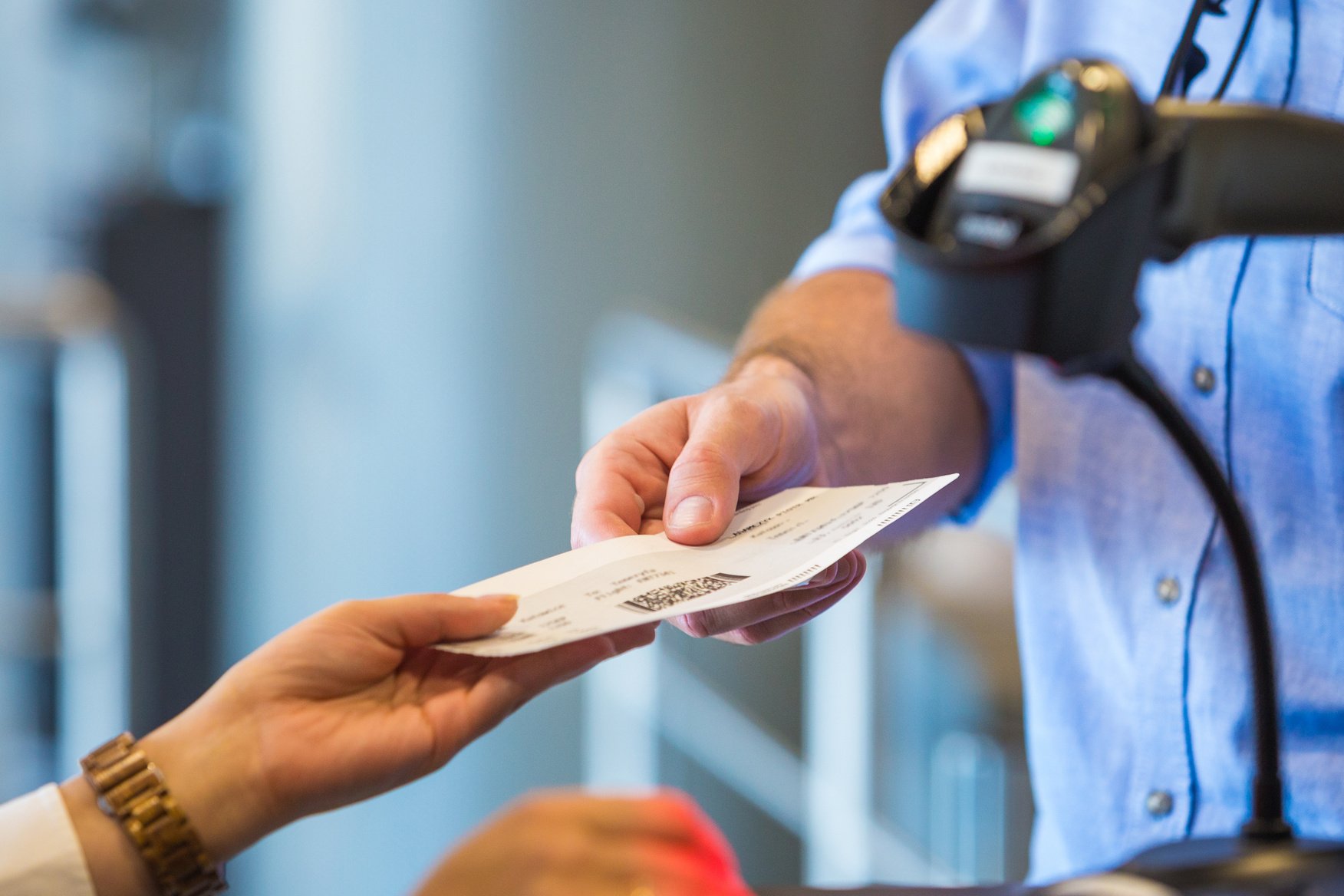 Airline attendant scanning airplane ticket